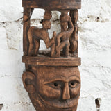 Ekaurr Tribal Crown Mask detail showing miniature hand-carved village figures on crown and expressive facial carving in aged reclaimed wood