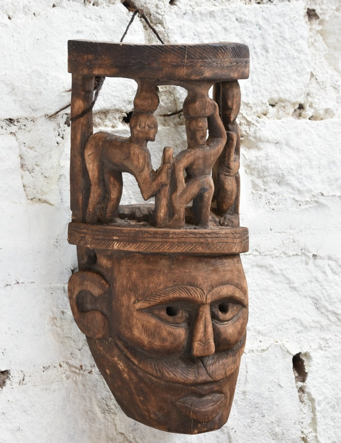 Ekaurr Tribal Crown Mask detail showing miniature hand-carved village figures on crown and expressive facial carving in aged reclaimed wood