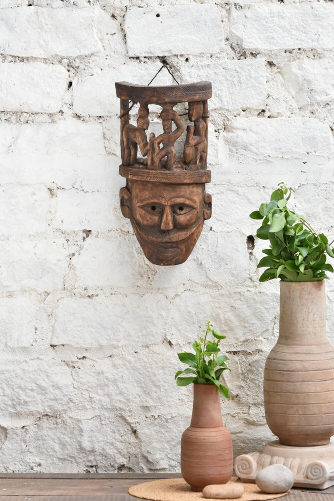 Ekaurr Tribal Crown Mask hand-carved wooden wall mask featuring village life scene carved atop the crown, vintage one-of-a-kind heritage statement décor