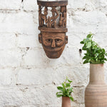 Ekaurr Tribal Crown Mask hand-carved wooden wall mask featuring village life scene carved atop the crown, vintage one-of-a-kind heritage statement décor