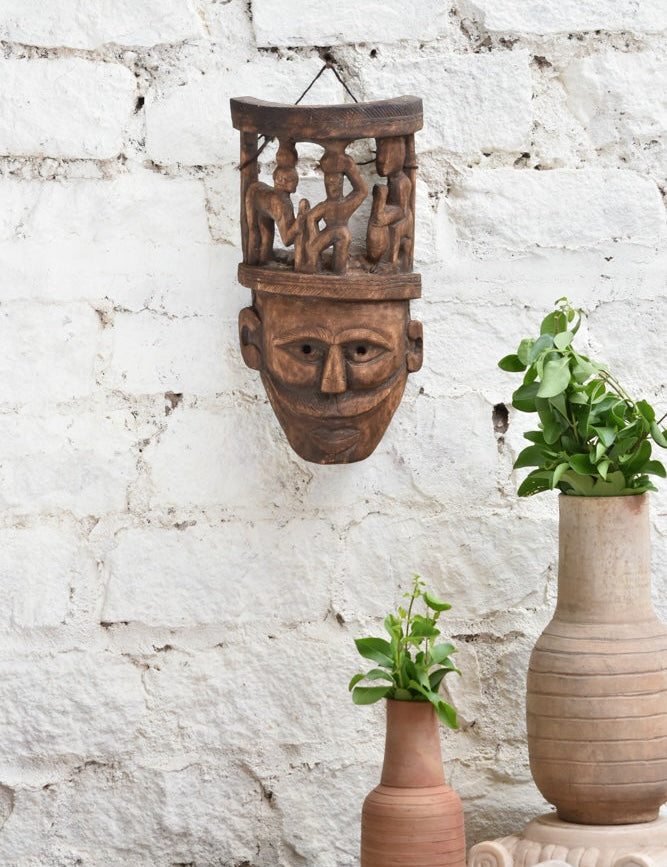 Ekaurr Tribal Crown Mask hand-carved wooden wall mask featuring village life scene carved atop the crown, vintage one-of-a-kind heritage statement décor
