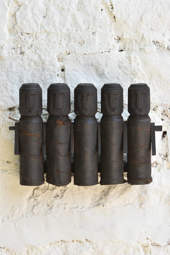 Ekaurr Tribal Wooden Dolls Set of 5 – abstract hand-carved silhouettes with rustic textures on a wall display