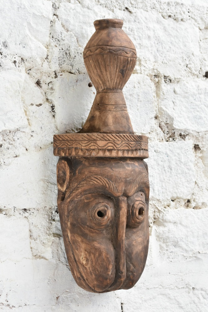 Ekaurr The Water Bearer Mask angled view showing depth of carving, natural wood grain and hand-chiselled detail
