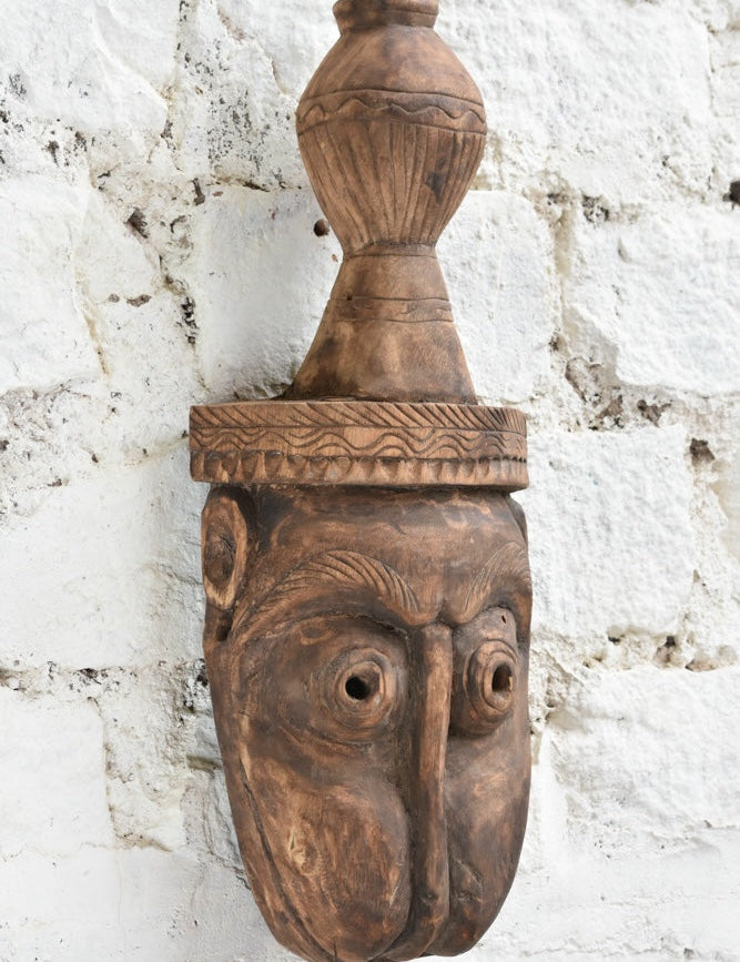 Ekaurr The Water Bearer Mask angled view showing depth of carving, natural wood grain and hand-chiselled detail