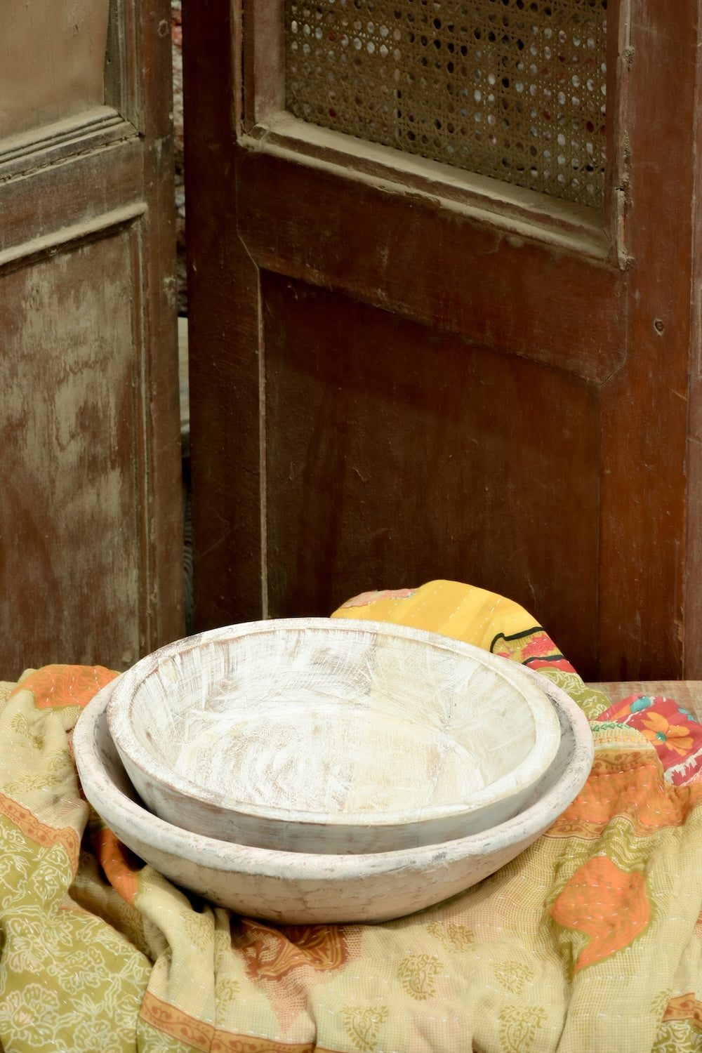 Ekaurr whitewashed round wooden trays styled as decorative display trays on a shelf or coffee table