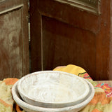Ekaurr whitewashed round wooden trays styled as decorative display trays on a shelf or coffee table