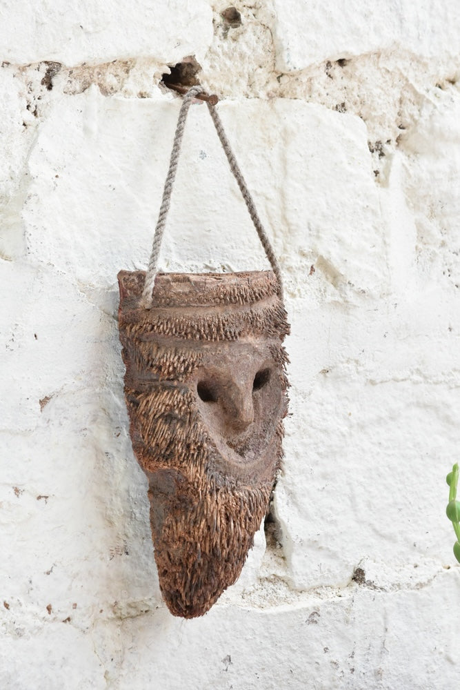 Detail view of Ekaurr Woodland Keeper wall mask showing carved botanical and woodland motifs with earthy natural finish