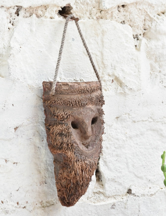 Detail view of Ekaurr Woodland Keeper wall mask showing carved botanical and woodland motifs with earthy natural finish