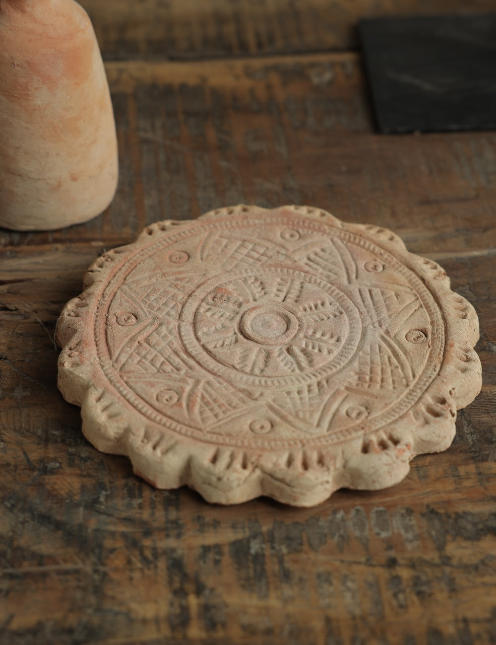 Ekaurr Terracotta Flower Design Riser handcrafted clay display stand with raised floral motif surface carving, earthy artisan pedestal for small sculptures candles or home decor accents